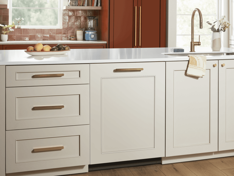 White countertop and cabinetry with gold details, including gold faucet in sink