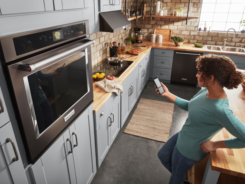 Person standing in front of a KitchenAid® wall oven