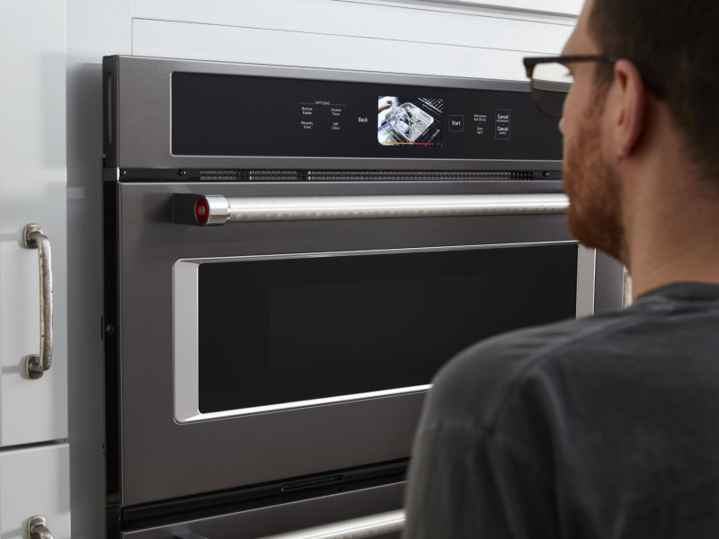 Person standing in front of a KitchenAid® wall oven