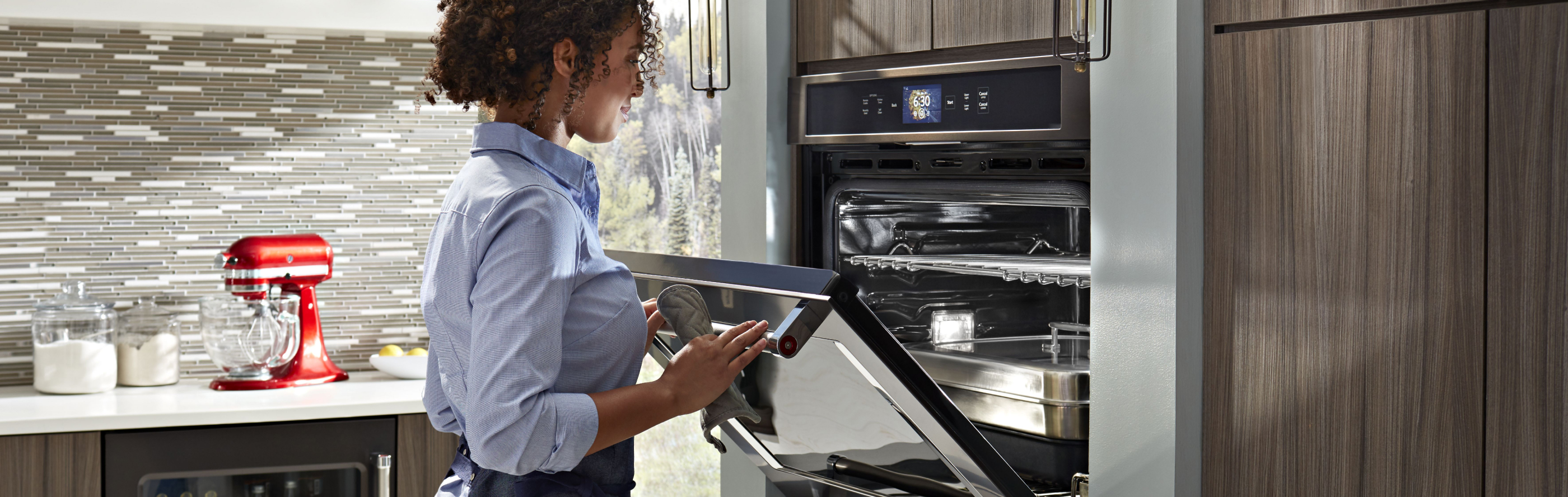 Person opening a KitchenAid® wall oven