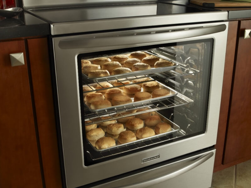 Glass oven door with rolls cooking inside