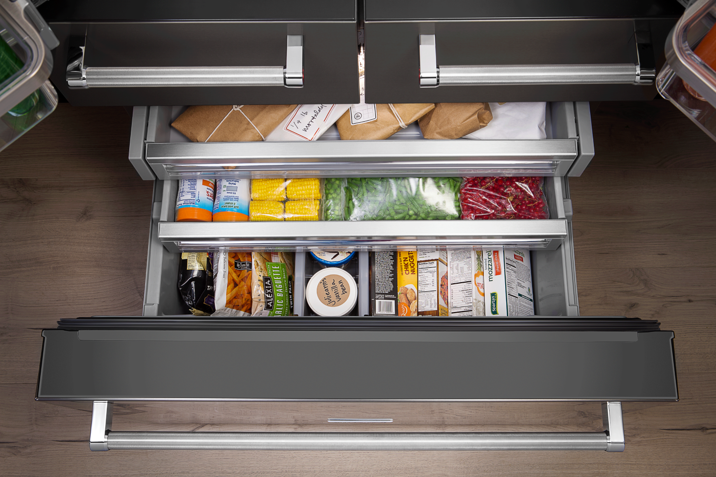 Overhead view of a freezer drawer filled with food Overhead view of a freezer drawer filled with food