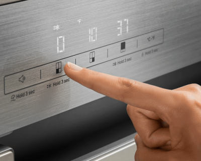 Person selecting refrigerator temperature setting