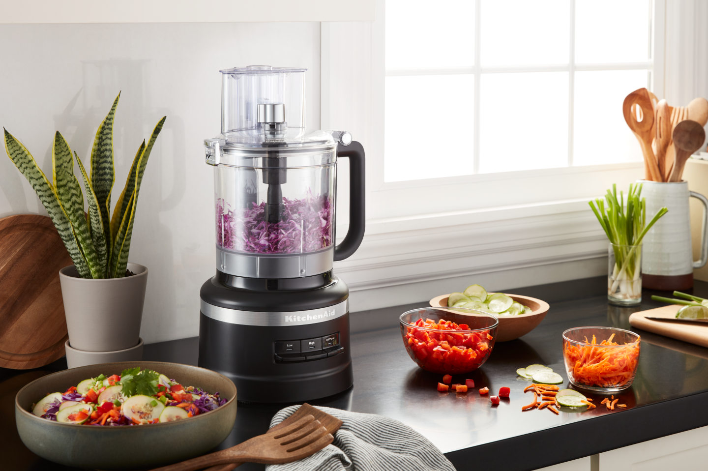 Shredded cabbage inside a black KitchenAid® food processor Shredded cabbage inside a black KitchenAid® food processor