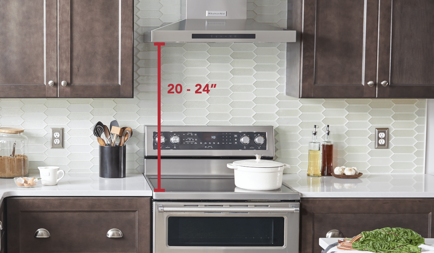 Stainless steel KitchenAid® range and range hood with measurements set in brown cabinetry Stainless steel KitchenAid® range and range hood with measurements set in brown cabinetry