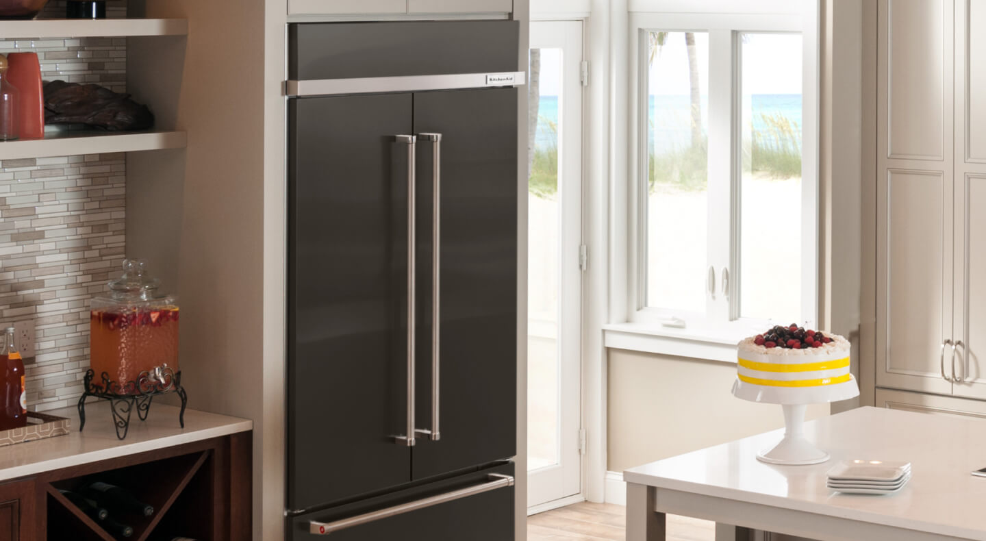 KitchenAid® built-in French door refrigerator next to gray tile backsplash