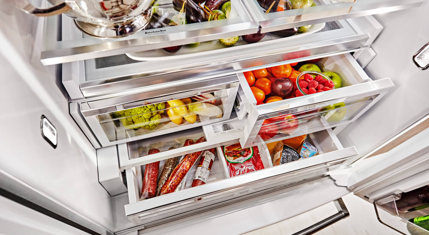 Stocked refrigerator with fruits and vegetables stored in crisper drawers Stocked refrigerator with fruits and vegetables stored in crisper drawers