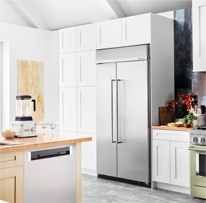 A built-in KitchenAid® refrigerator surrounded by white cabinetry