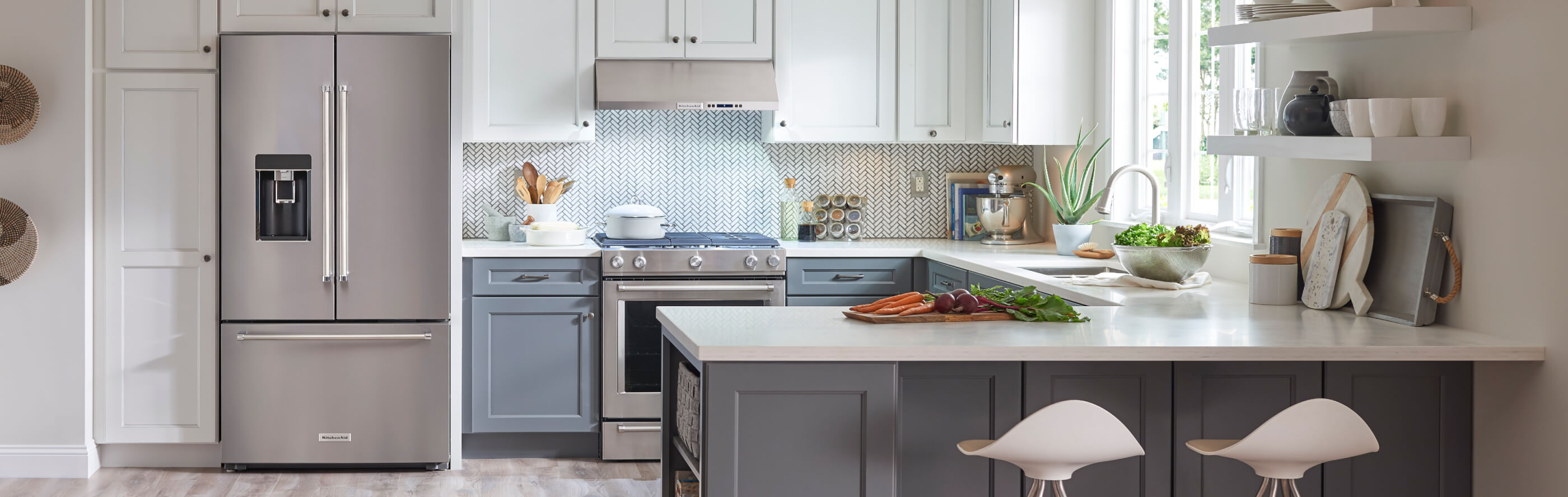A stainless steel KitchenAid® French door refrigerator in a modern kitchen