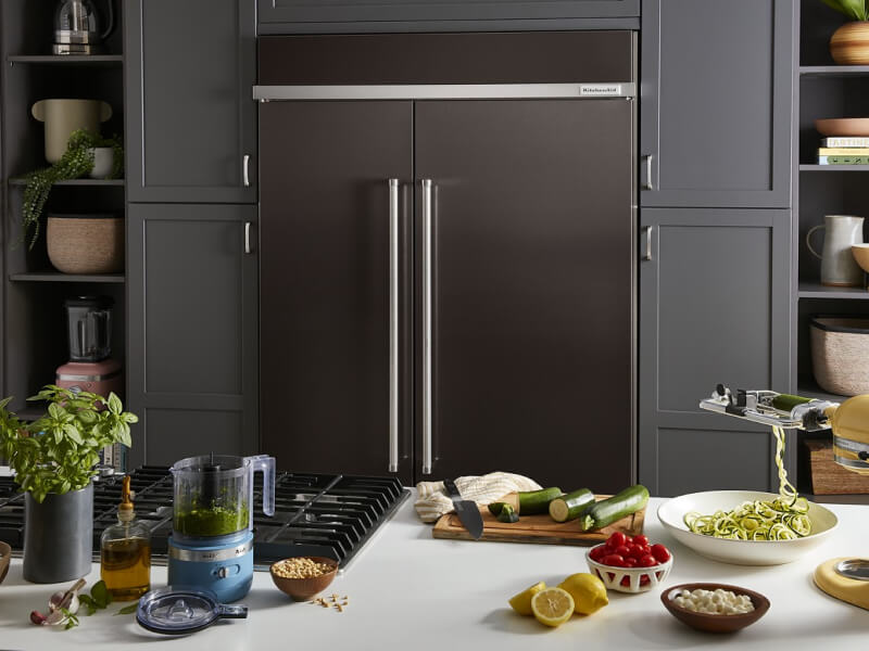 Black stainless steel KitchenAid® French door refrigerator behind kitchen island