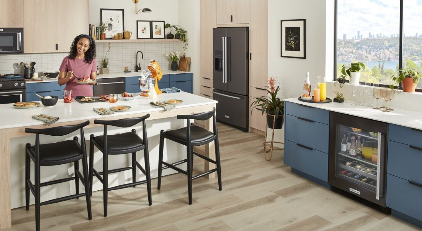 Person eating inside a contemporary kitchen Person eating inside a contemporary kitchen