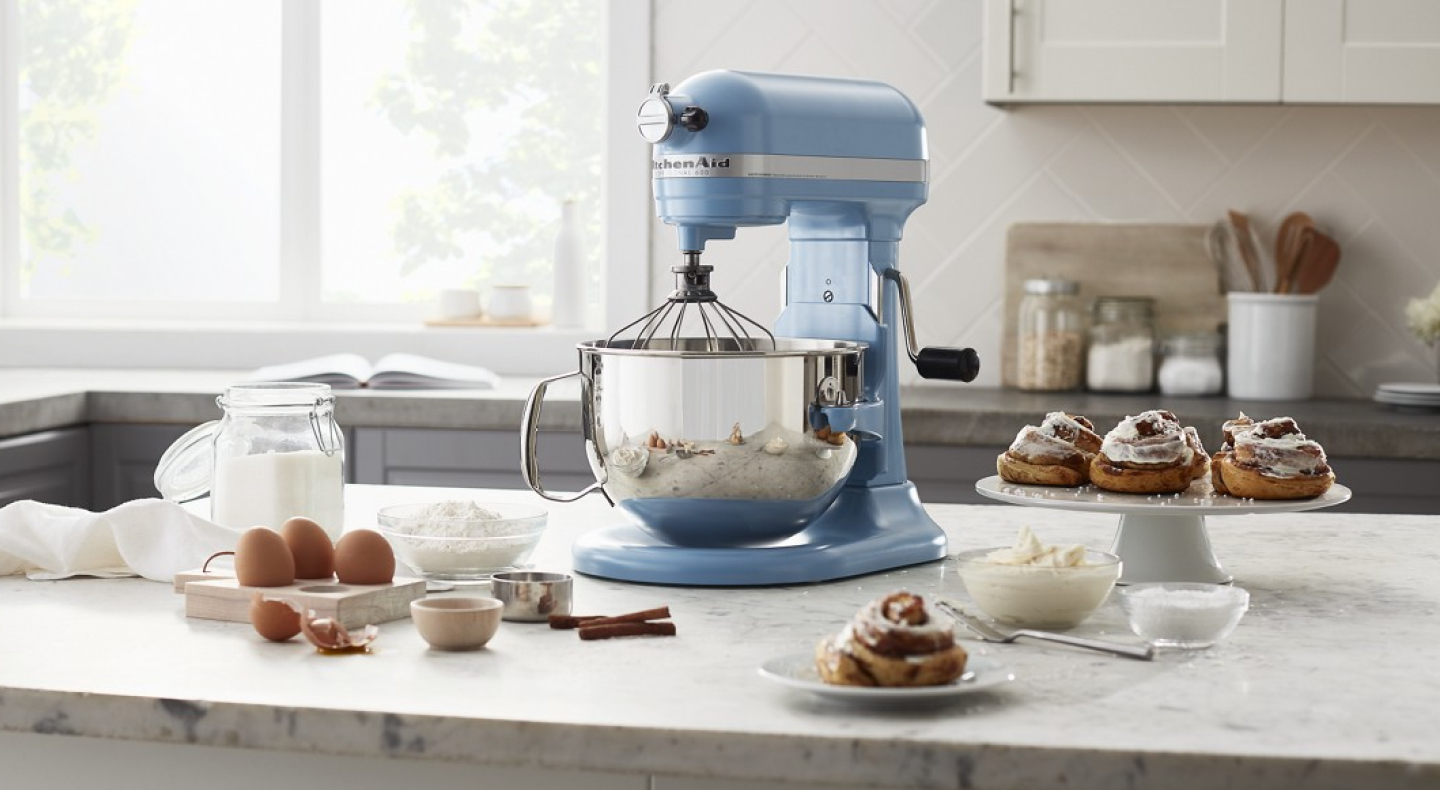 Blue KitchenAid® stand mixer on a white countertop 