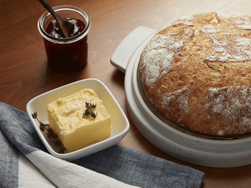 Butter next to bread on a countertop Butter next to bread on a countertop