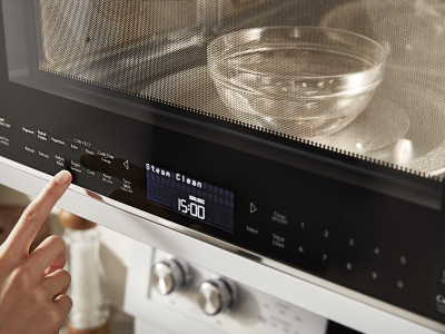 Person warming water in a microwave