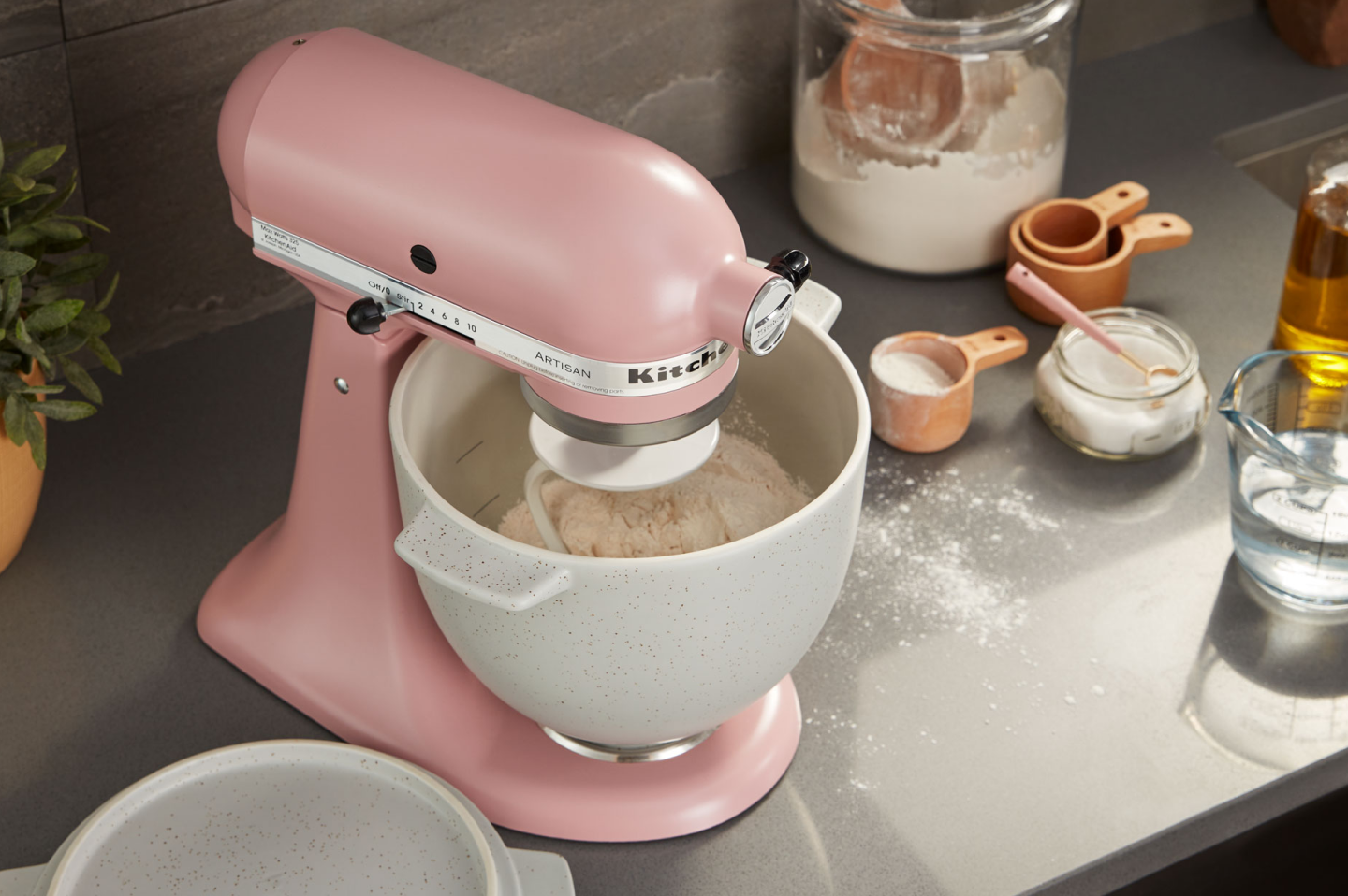 Pink stand mixer with white speckled stand mixer bowl full of flour Pink stand mixer with white speckled stand mixer bowl full of flour