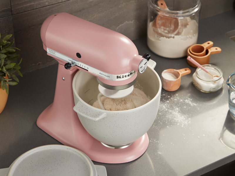 Pink stand mixer with white speckled stand mixer bowl full of flour Pink stand mixer with white speckled stand mixer bowl full of flour