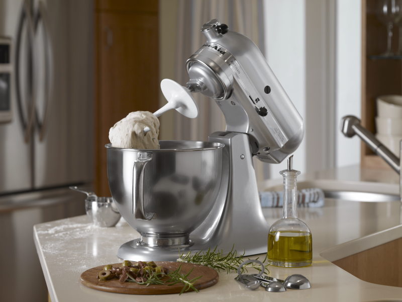 Tilt-head silver KitchenAid® Stand Mixer tilted upward with dough hanging on the dough hook above the mixing bowl 