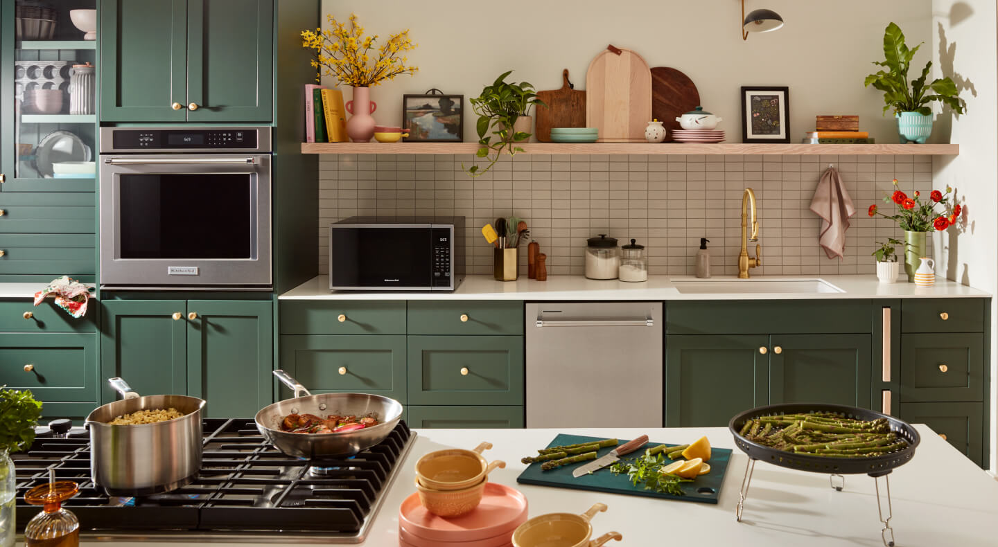 KitchenAid® appliances built into green cabinetry