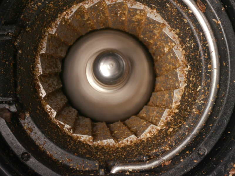 Close-up of coffee in a burr grinder Close-up of coffee in a burr grinder