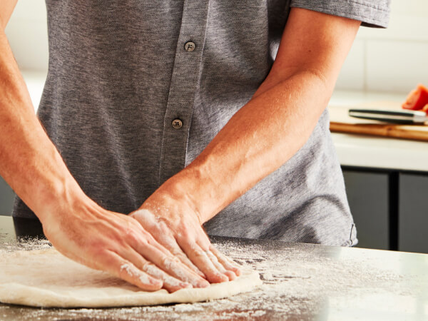 Person stretching dough