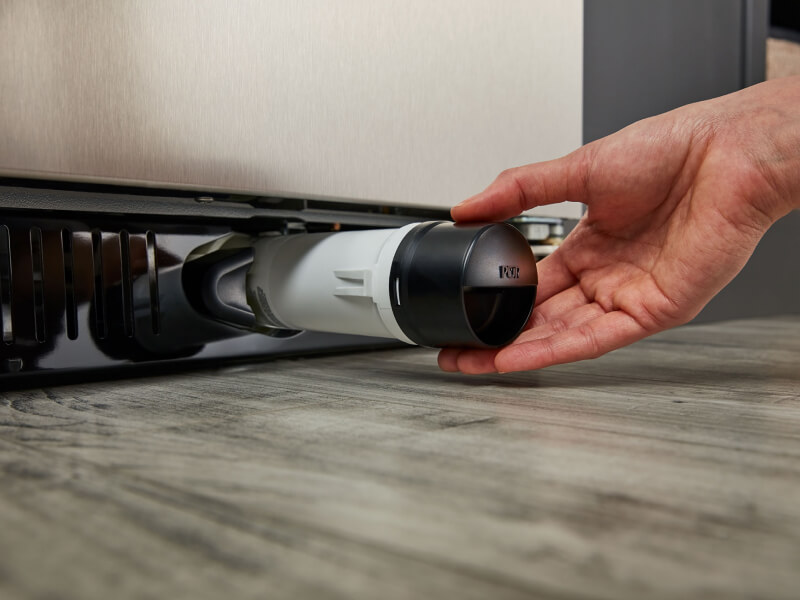 Person removing refrigerator water filter Person removing refrigerator water filter