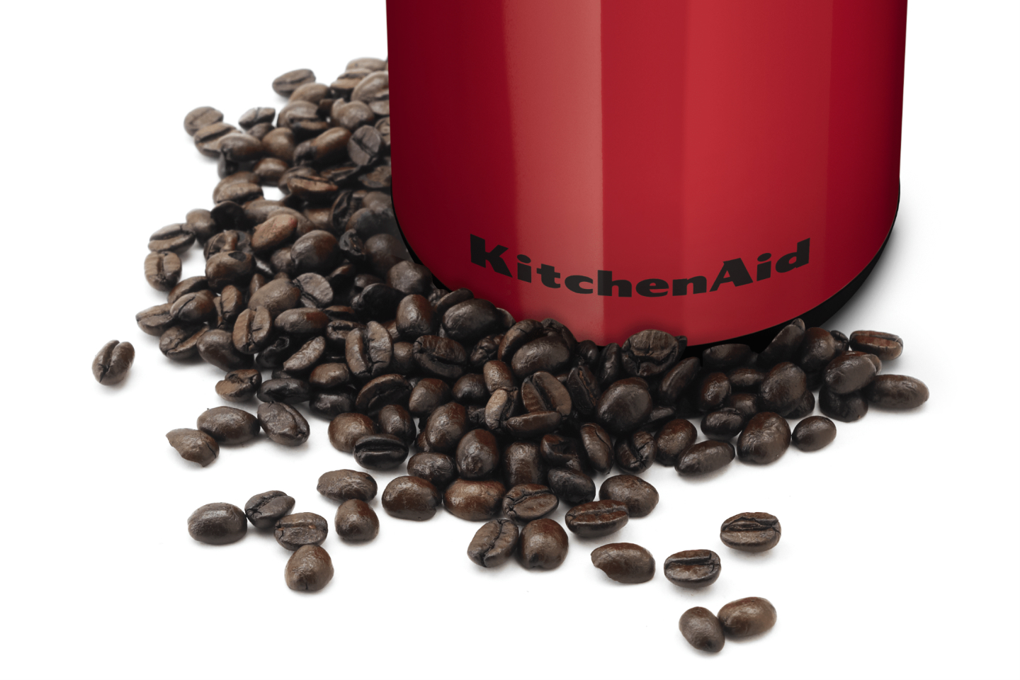 Whole coffee beans in front of a red KitchenAid® coffee grinder Whole coffee beans in front of a red KitchenAid® coffee grinder