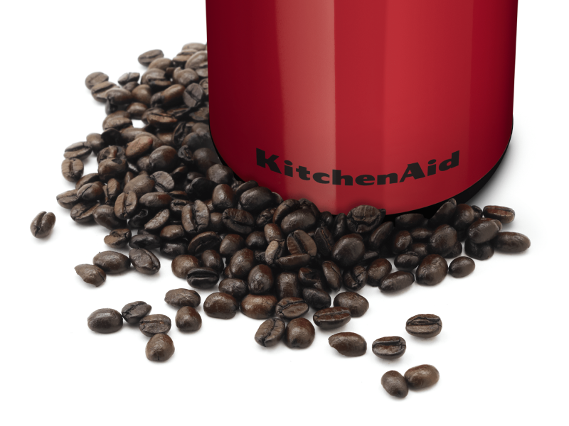 Whole coffee beans in front of a red KitchenAid® coffee grinder Whole coffee beans in front of a red KitchenAid® coffee grinder