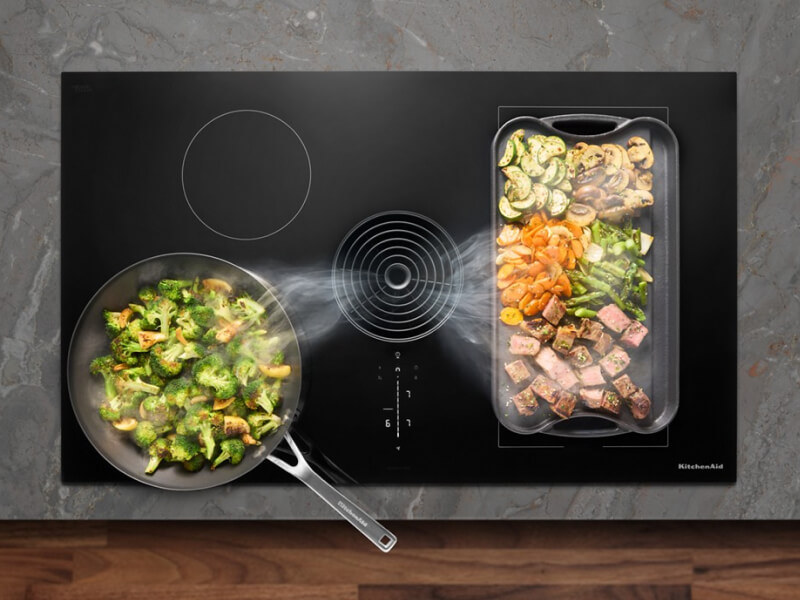 Food cooking on a cooktop with steam rising from it Food cooking on a cooktop with steam rising from it