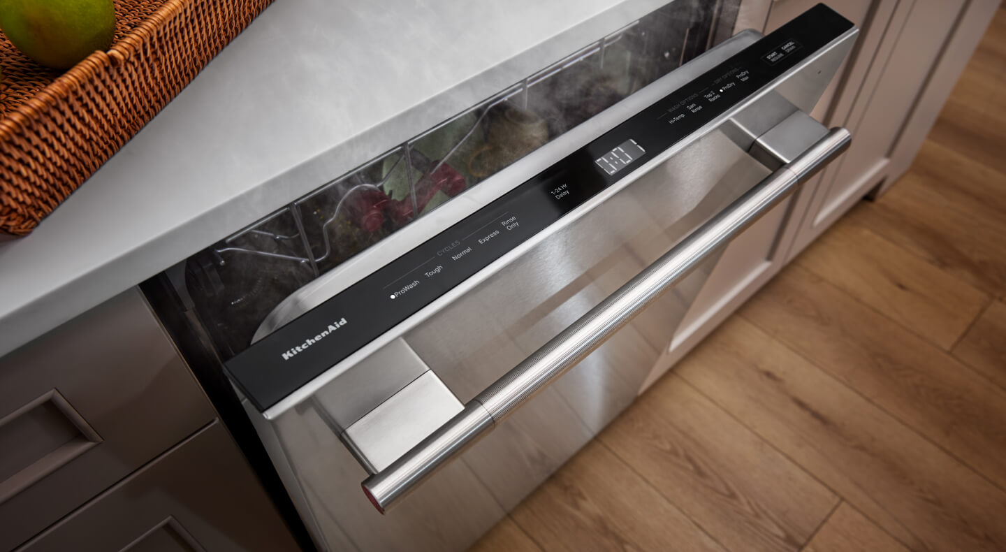 Dishwasher cracked open with clean dishes inside and steam rising