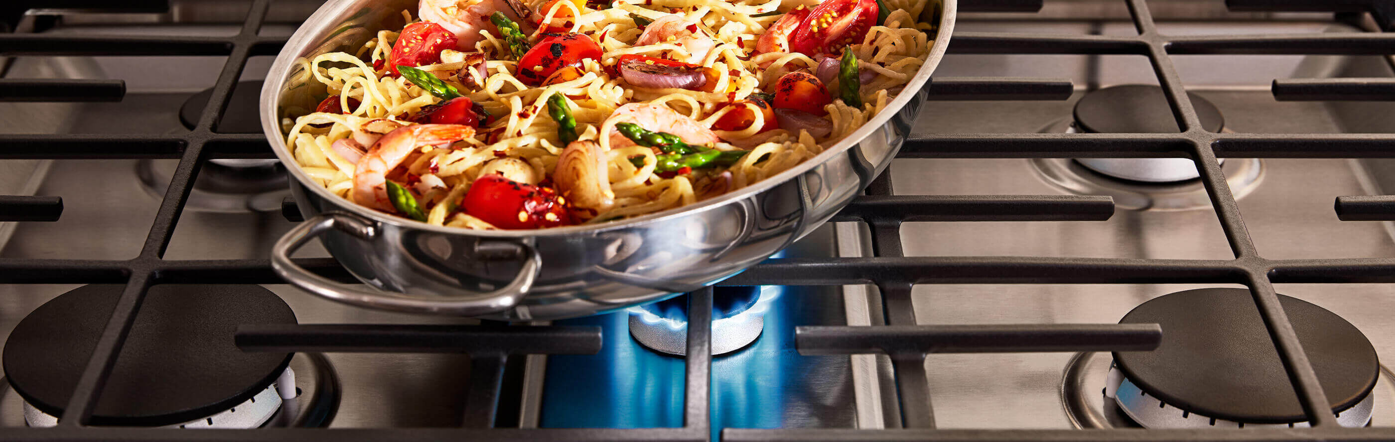Pasta in a pan on a gas stove burner