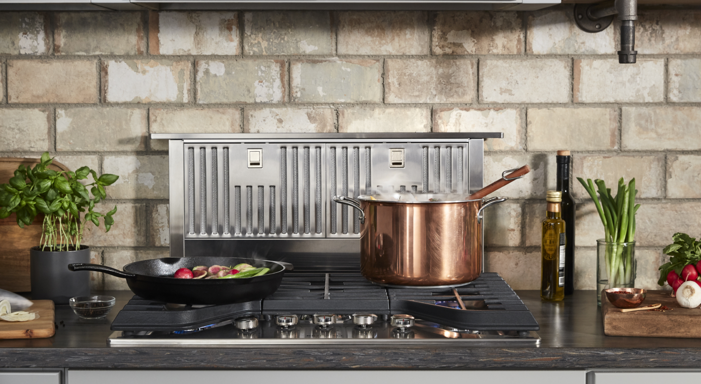 Retractable downdraft hood behind a gas range Retractable downdraft hood behind a gas range