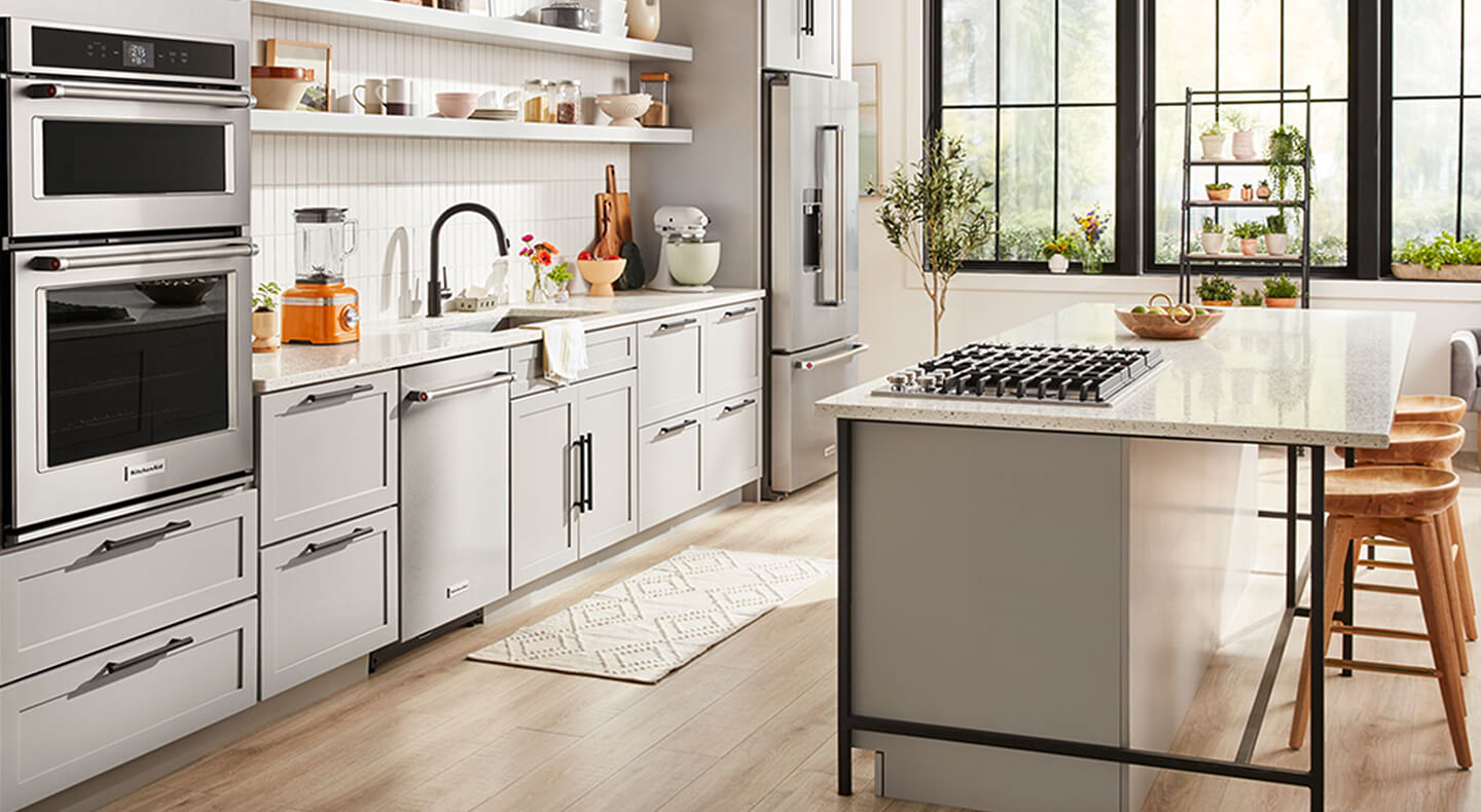 A light and bright one-wall kitchen layout with stainless steel appliances
