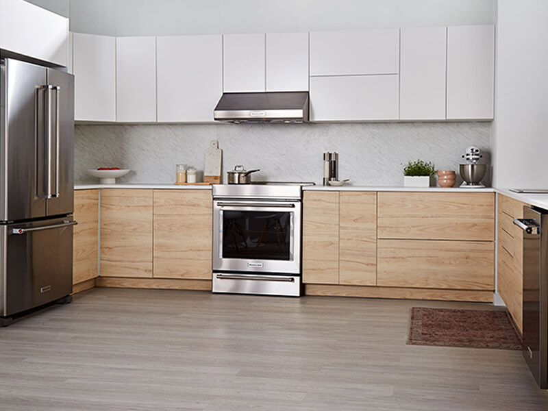 A light, spacious u-shaped kitchen layout with stainless steel appliances A light, spacious u-shaped kitchen layout with stainless steel appliances