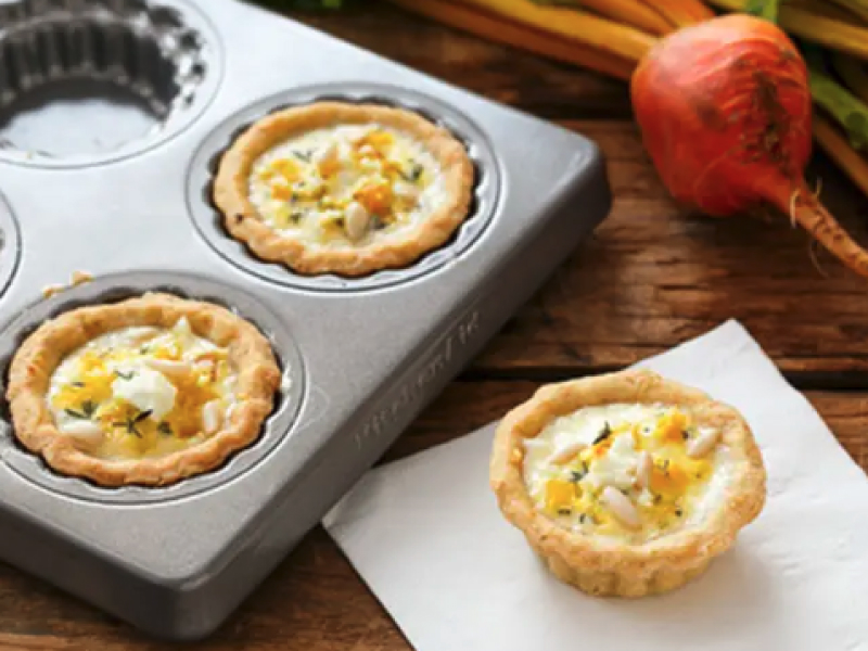 A golden beet and goat cheese quiche resting on a napkin