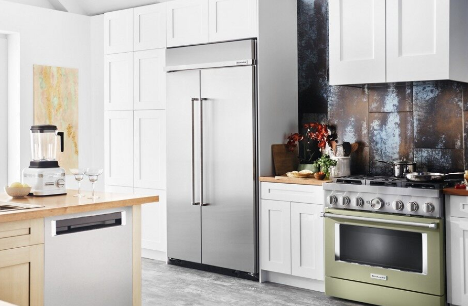 Built-in refrigerator style installed in white cabinets in modern kitchen Built-in refrigerator style installed in white cabinets in modern kitchen