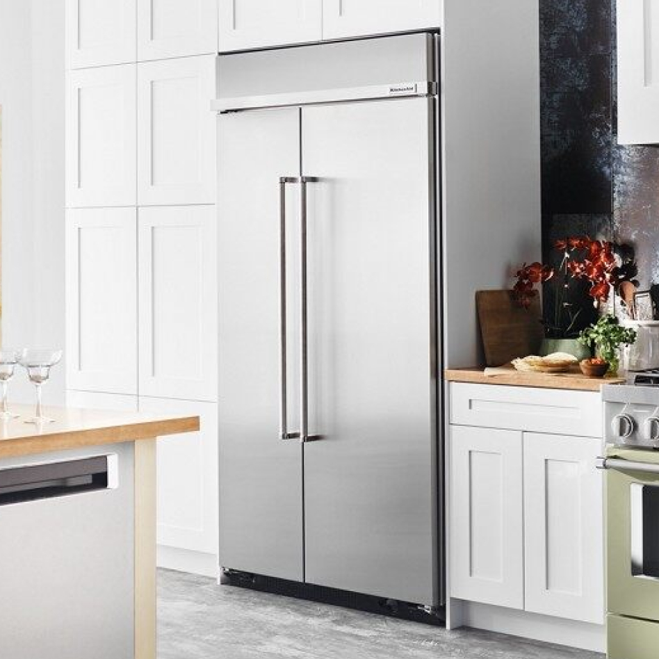Built-in refrigerator style installed in white cabinets in modern kitchen Built-in refrigerator style installed in white cabinets in modern kitchen