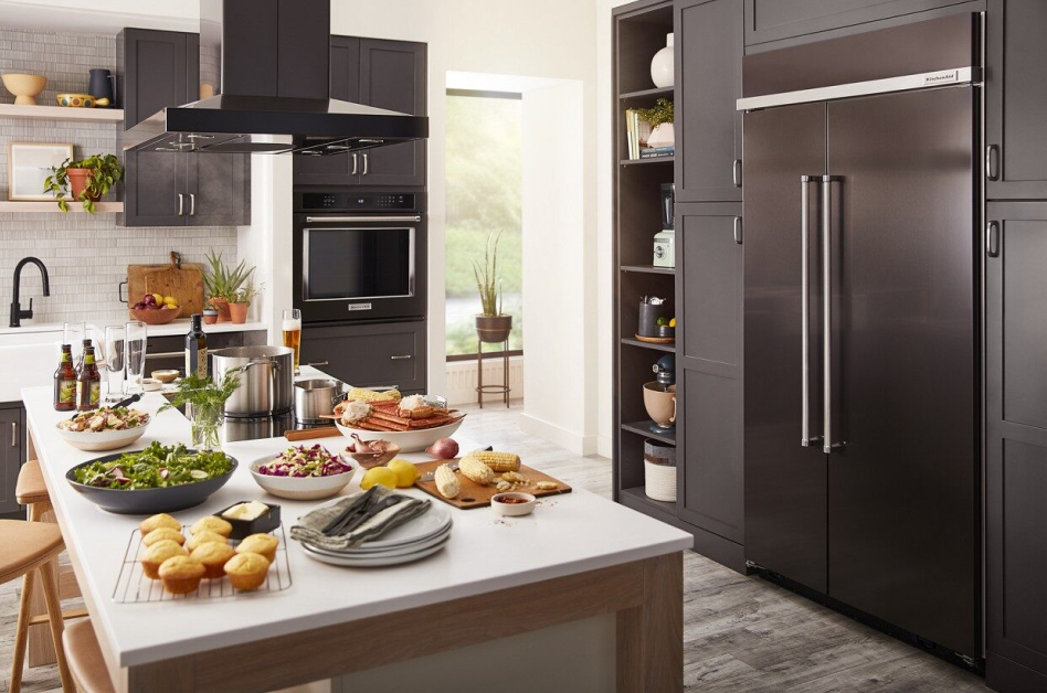 Black stainless steel refrigerator style in dark, modern kitchen Black stainless refrigerator style in modern kitchen