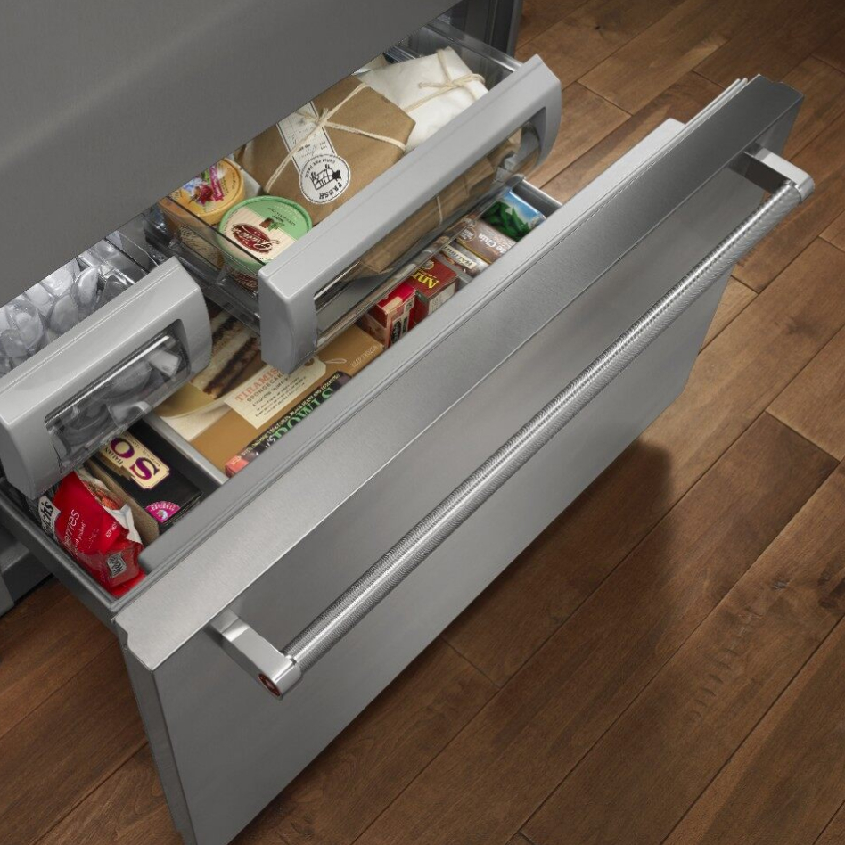 Open bottom freezer refrigerator drawer with food inside Open bottom freezer refrigerator drawer with food inside