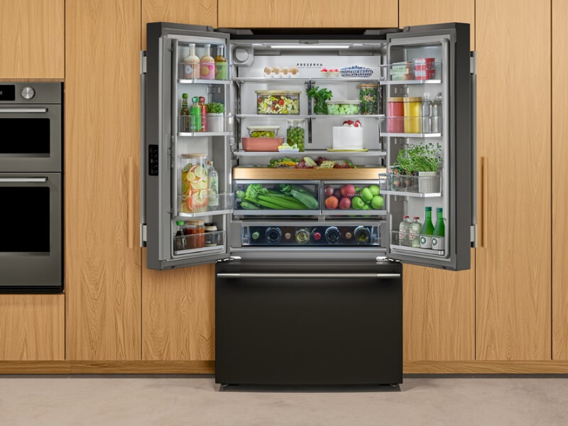 A black stainless steel refrigerator with French doors that are open and exposing food