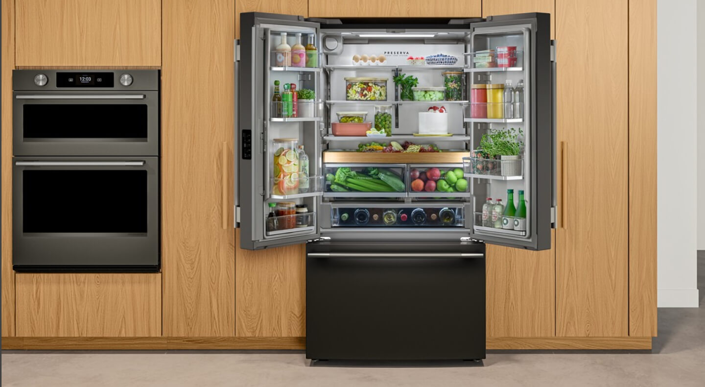 A black stainless steel refrigerator with French doors that are open and exposing food