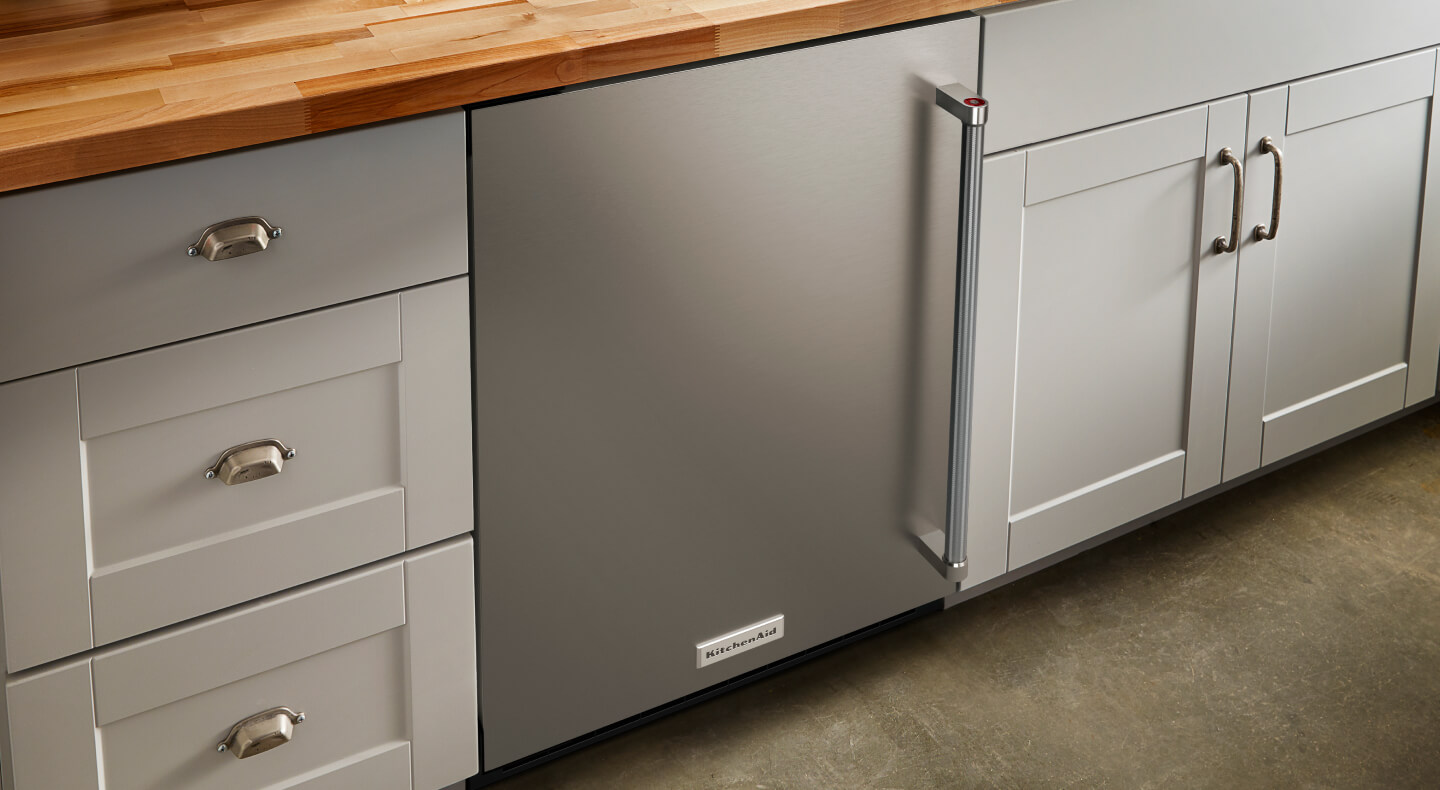 KitchenAid® stainless steel undercounter refrigerator built into kitchen cabinets