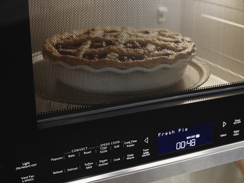 A closeup of a KitchenAid® microwave baking a pie. A closeup of a KitchenAid® microwave baking a pie.