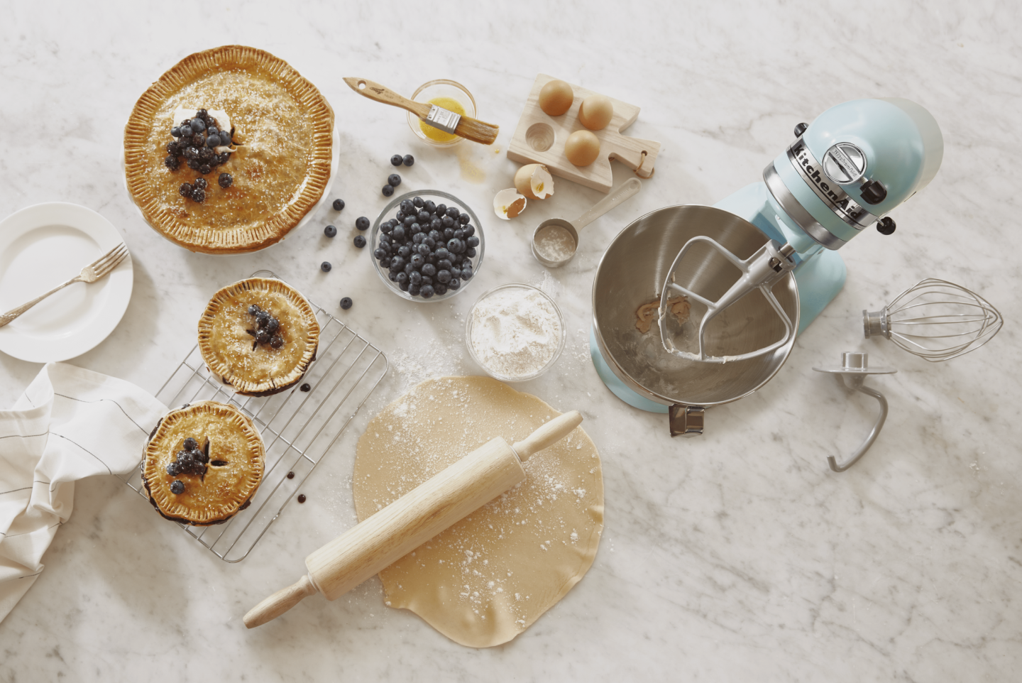 Top view of large blueberry pie and two smaller pies along with KitchenAid® stand mixer on countertop Top view of large blueberry pie and two smaller pies along with KitchenAid® stand mixer on countertop