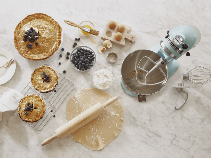 Top view of large blueberry pie and two smaller pies along with KitchenAid® stand mixer on countertop Top view of large blueberry pie and two smaller pies along with KitchenAid® stand mixer on countertop