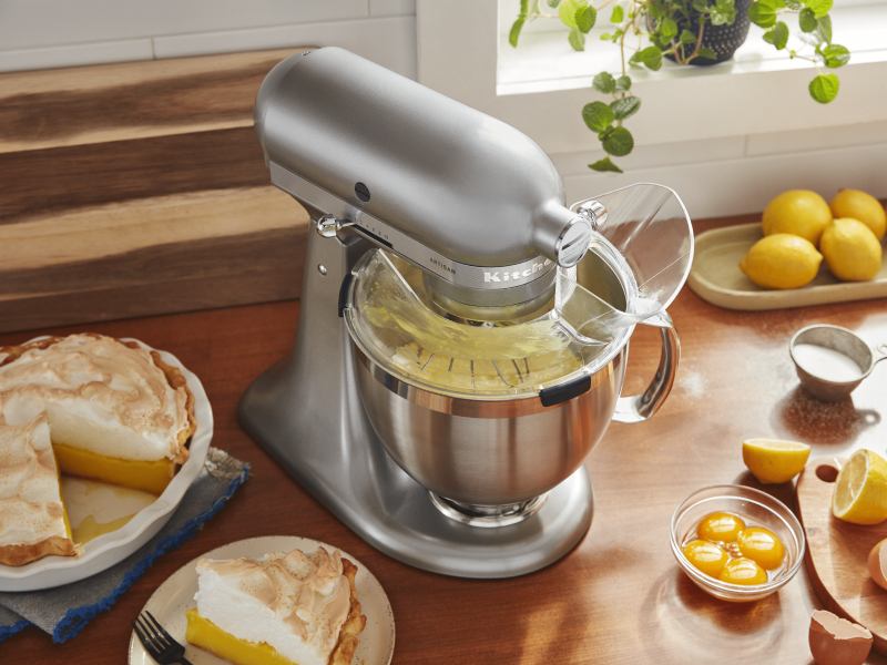 Silver KitchenAid® stand mixer with Pour Shield on countertop with lemon meringue pie and ingredients Silver KitchenAid® stand mixer with Pour Shield on countertop with lemon meringue pie and ingredients