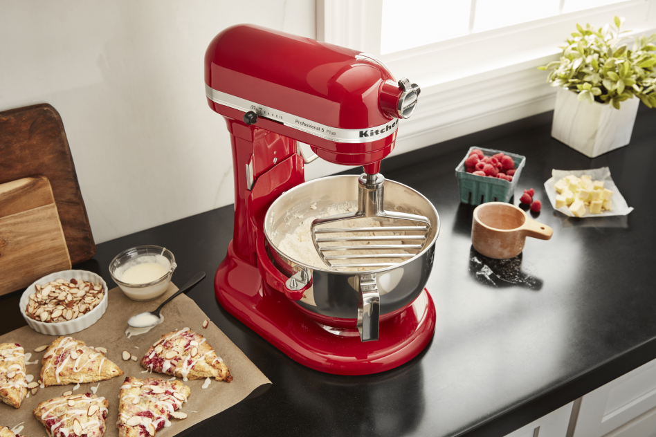 Red KitchenAid® stand mixer mixing pastry dough on countertop Red KitchenAid® stand mixer mixing pastry dough on countertop