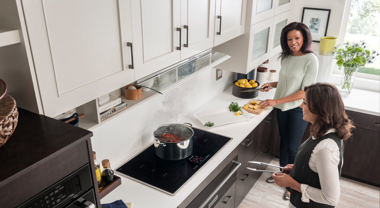 Two people cooking in a kitchen Two people cooking in a kitchen