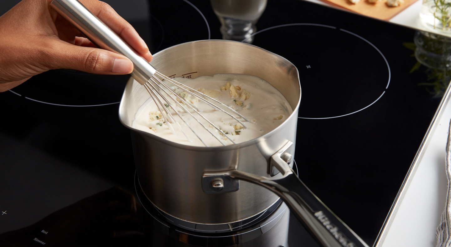 Person whisking a sauce Person whisking a sauce