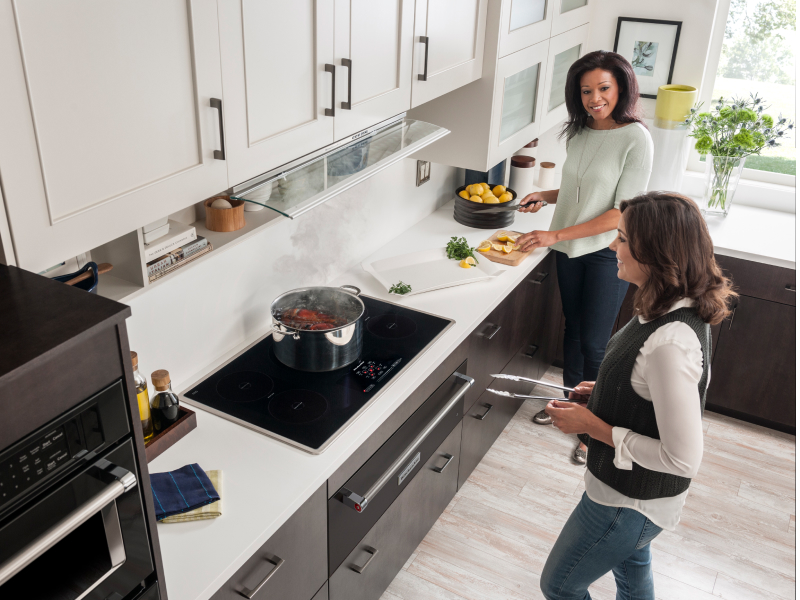 Two people cooking in a kitchen Two people cooking in a kitchen