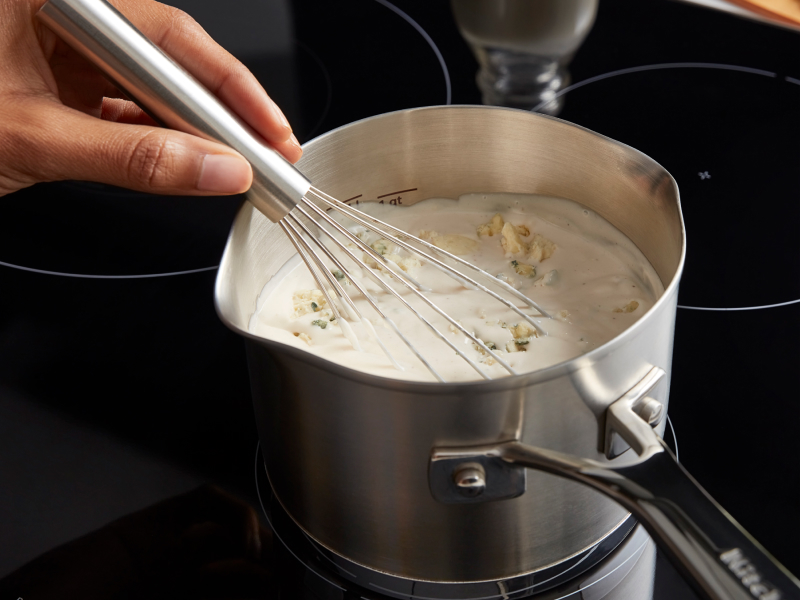 Person whisking a sauce Person whisking a sauce